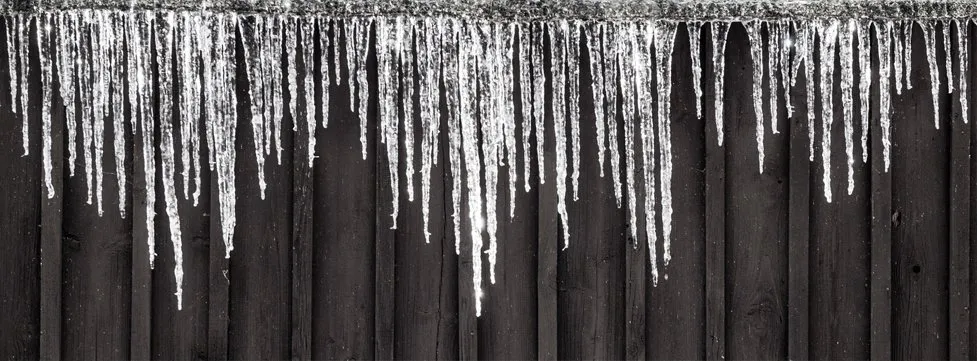 How does snow and ice affect a flat roof?