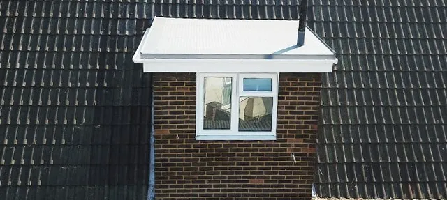 What are the advantages of a flat roof compared to a pitched roof?